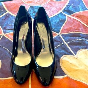 Coach black patent leather pumps.